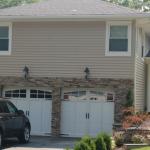 The front of the house gets a face lift with Charter Oak Seamless siding and real stone veneer. 