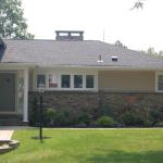 Two extra touches: A custom-built portico with white columns and a newly raised chimney that can now be seen from the front side. 