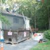 Netting protects the house and roofing materials are neatly stacked and ready to go. 